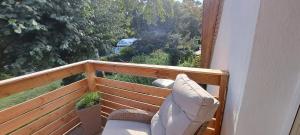 a balcony with a bench and a view of a yard at Ferienwohnung Ruhepol in Altefähr +9 photos