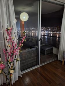 a room with a window with a view of the city at Depto.encantador frente al mar in Iquique