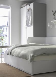a white bedroom with a white bed and a window at Centro Lugo in Lugo