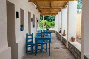 a row of blue tables and chairs on a patio at Amaragua in Fiambala
