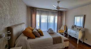 a bedroom with a bed and a dresser and a window at Casa Las 7 Maravillas in Fuentidueña de Tajo +72 photos