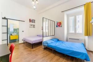 a bedroom with two beds and a mirror at CASA DI SILVIA a PORTA PIA in Rome