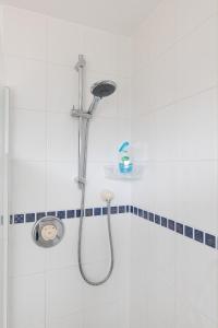 a shower with a shower head in a bathroom at Foss Flat in York