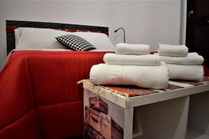 a pile of towels sitting on top of a bed at La Dagala in Catania