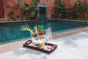 a tray with two wine glasses and a bowl of fish at Alanta Private Pool Villa in Ko Lanta