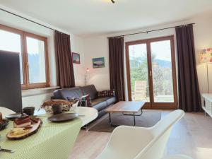 a living room with a couch and a table at Appartements Skida in Reith bei Kitzbühel