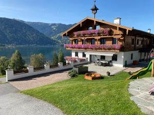 a large building with a view of a lake at Erlbruckhof in Zell am See