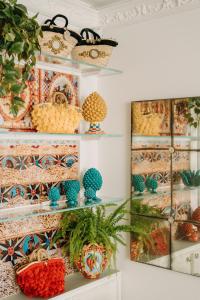 a shelf filled with different types of baskets and plants at Palazzo Natoli Boutique Hotel in Palermo