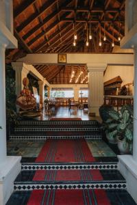 a lobby with a large room with a red rug at Aadisaktthi Leisure Resort, Kovalam in Trivandrum