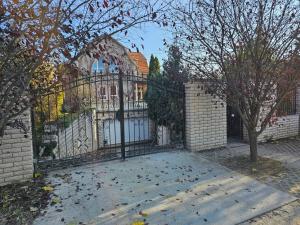 a gate to a house with a fence at Relax & Wellness Villa Diósd in Budapest