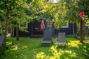two chairs and an umbrella in a yard at Ferienhaus Paula in Leipe