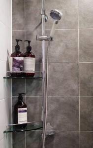 a shower with two bottles on a shelf in a bathroom at Serene Space Seoul in Seoul