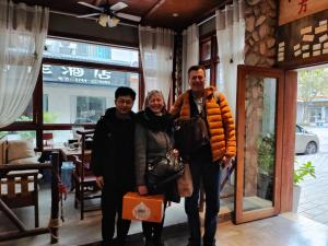 a group of people standing in front of a store at Zhangjiajie Highlights Guesthouse in Zhangjiajie