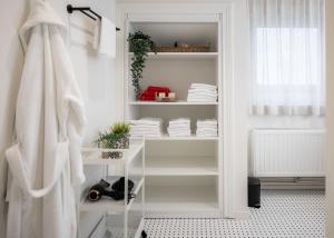 a white closet with white shelves and towels at Belcoast Guesthouse in Middelkerke +34 photos