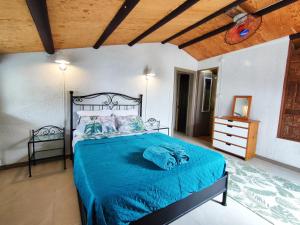 a bedroom with a bed with a blue comforter at Mermaid Cove in Blue Bay