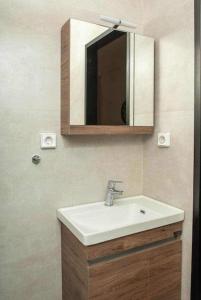 a bathroom with a sink and a mirror at Flat in Athens next to Metro st! in Athens