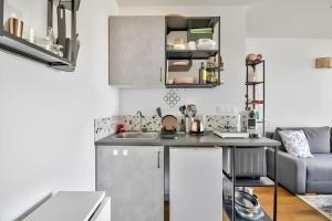 a kitchen with a sink and a counter top at Soleil du canal Saint Martin in Paris