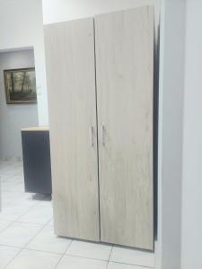 a pair of wooden cabinets in a room at Mary cozy house in Athens