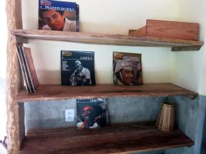 a wooden shelf with movies and dvds on it at YbYmara Eco Glamping in Serra Grande