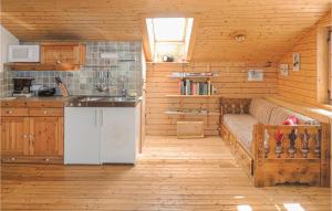 a kitchen with a bed in a wooden room at Nice Home In Klein St, Paul With Kitchen in Eberstein