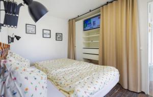 a bedroom with a bed and a tv on the wall at Ferienhaus Mit Panoramablick in Eberau