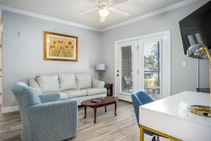 a living room with a couch and chairs and a table at Park Avenue 109 in Foley