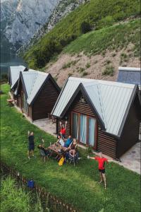 a group of people playing frisbee in front of a cabin at 5 Stinet in Koman