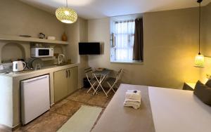 a living room with a kitchen and a table and a microwave at The Easy Rooms Terrace in Antalya +26 photos