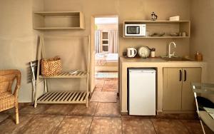 a kitchen with a white refrigerator and a microwave at The Easy Rooms Terrace in Antalya