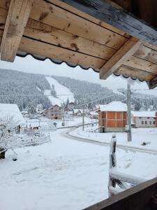 a view from a balcony of a snow covered village at Cabana Rosie in Vartop