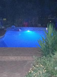 a large blue swimming pool at night at Our Place - Family - 5 bed unit in Bloemfontein
