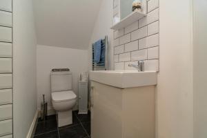 ein weißes Badezimmer mit Waschbecken und Toilette in der Unterkunft Light airy 3 bed Town Cntr flat 700m to the Beach in Bournemouth + 24 Fotos