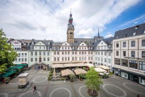 a large white building with a clock tower at 140qm 3BR apartment - central, cozy and stylish in Koblenz