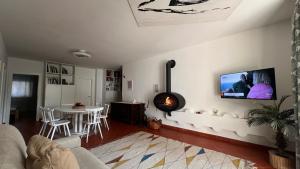 a living room with a table and a tv on the wall at Garden Suite in Bolzano