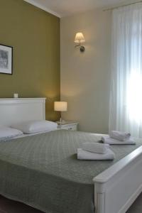a bedroom with a large bed with two pillows on it at Villa Hara, Lixouri, Kefalonia in Lixouri