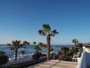 a view of the ocean from the balcony of a resort at Sea view with direct access to boulevard in Puerto del Carmen