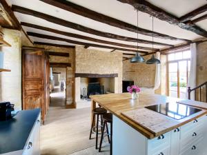 a kitchen with a large island with a counter top at Moon River Grande Maison in Saint-Cyprien