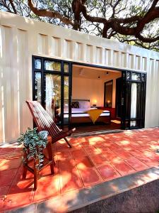 a room with a bed and a patio at CooCasa in Mahabaleshwar