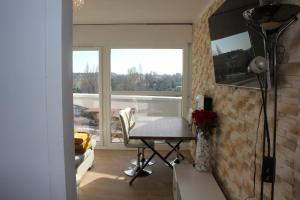 a dining room with a table and a window at Appart T3 kodjo in Pessac