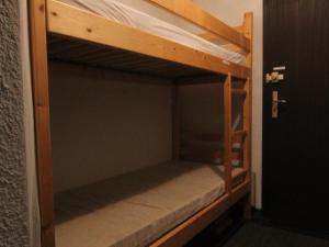 a bunk bed in a room with a door open at Appartement Huez, 1 pièce, 4 personnes - FR-1-405-108 in L'Alpe-d'Huez