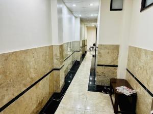 a hallway with a row of tiles on the walls at grover international in Bathinda