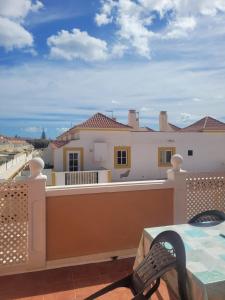 a balcony with a view of a house at Apartamento funcional en residencial con piscina en inmejorable ubicación en centro de la isla in Caleta De Fuste