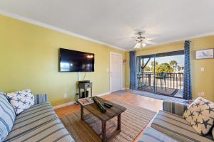 a living room with a couch and a tv at Beach Villa 2 Bedroom in Clearwater Beach