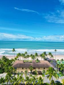 an aerial view of a resort with palm trees and the beach at Beira Mar Porto de Galinhas Hotel in Porto De Galinhas