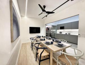 a dining room with a table and chairs and a ceiling fan at Designer Guesthouse Pulau Tikus & Gurney Drive, Georgetown, Penang in George Town