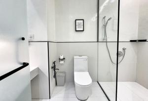 La salle de bains est pourvue d'une douche et de toilettes. dans l'établissement Designer Guesthouse Pulau Tikus & Gurney Drive, Georgetown, Penang, à George Town