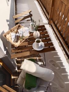 a table on a balcony with two cups of coffee at Biohof-Feichtinger in Zell am Moos