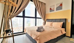 a bedroom with a bed with two towels on it at Cozy Minimalist Suite at Georgetown by SuperStay in Jelutong