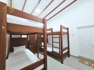 two bunk beds in a room with a window at Galle Face Terrace Hostel by Tourlux in Colombo