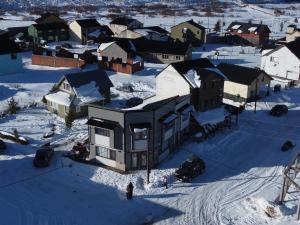 an aerial view of a house in the snow at La Cantonada in Caviahue